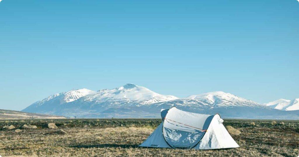 Simple tented safari camp at sunrise showing affordable African safari accommodation option