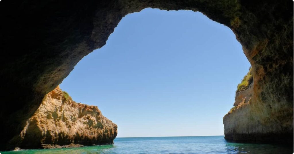 Golden limestone cliffs and turquoise Atlantic water at an Algarve beach on Portugal's southern coastline
