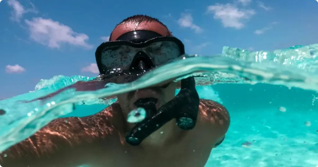 Best snorkel mask for large face — wide-fit silicone skirt seal at rocky reef entry point