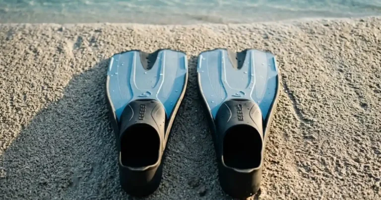 Best Snorkeling Fins for Travel: Compact, Lightweight & Tested Best snorkeling fins for travel laid on tropical beach sand ready for reef snorkeling