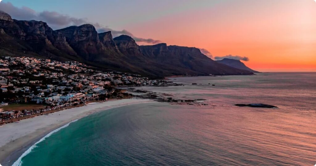 Cape Town travel guide — aerial view of Table Mountain with Camps Bay beach and Atlantic Ocean below