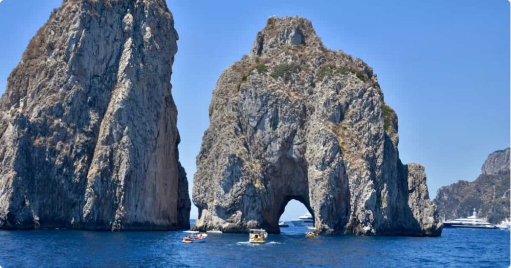 Capri, Italy: Complete Island Travel Guide Aerial view of Capri island Italy with turquoise water and limestone cliffs, Bay of Naples