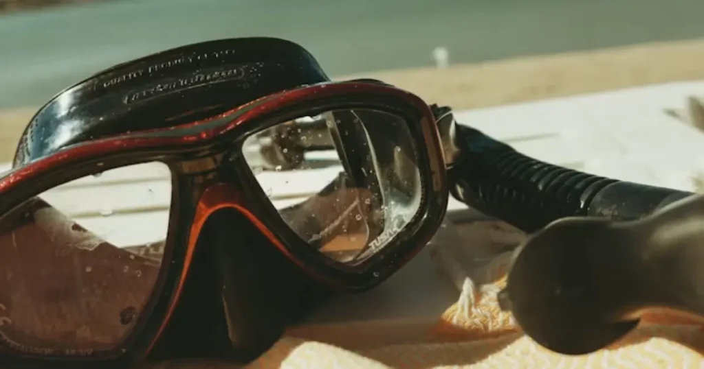 Full face snorkel mask versus traditional two-piece mask on volcanic rock