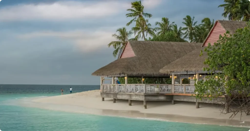 Local island guesthouse shoreline in the Maldives showing affordable accommodation alternative to luxury resorts