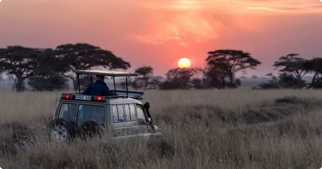Small group safari vehicle on Serengeti plains — mid-range safari tour operators Africa reviewed