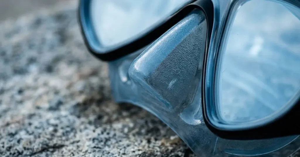 Close-up of snorkel mask silicone skirt and tempered glass lens showing material quality after repeated saltwater use