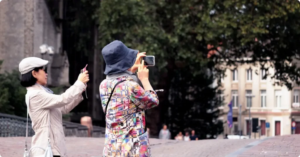 Traveler holding smartphone with eSIM app open, airport background, Airalo eSIM review