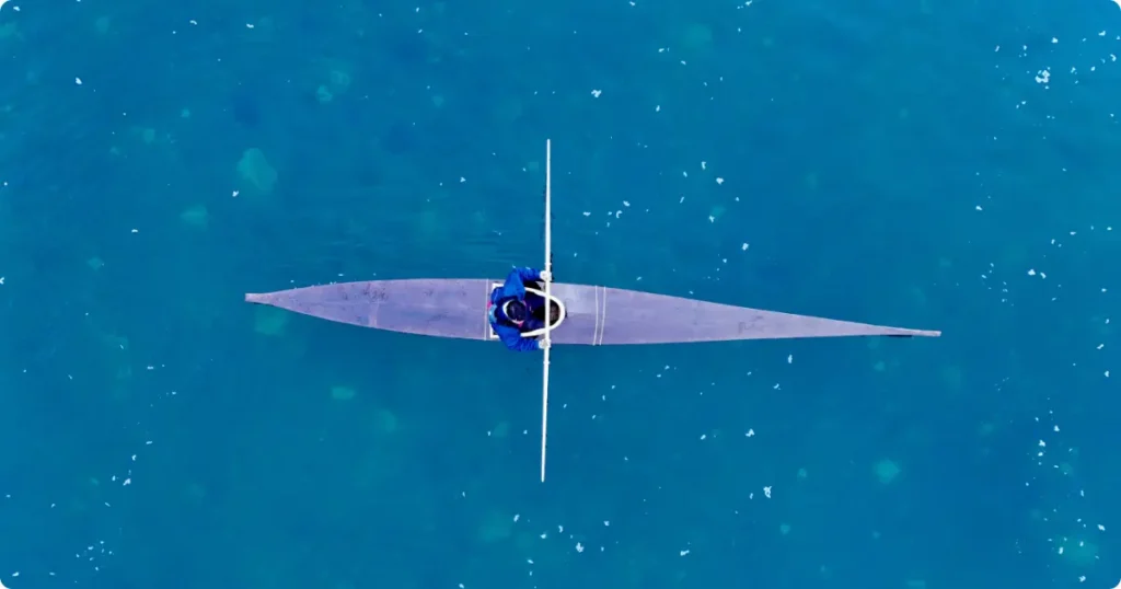 Best Kayaking Destinations for USA & UK Travelers: Ranked by Type Solo kayaker paddling through a glacial fjord at golden hour — best kayaking destinations for travelers