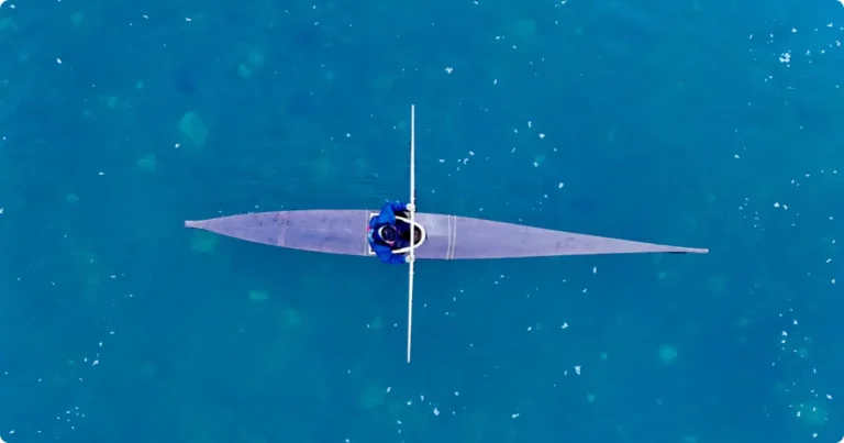 Best Kayaking Destinations for USA & UK Travelers: Ranked by Type Solo kayaker paddling through a glacial fjord at golden hour — best kayaking destinations for travelers