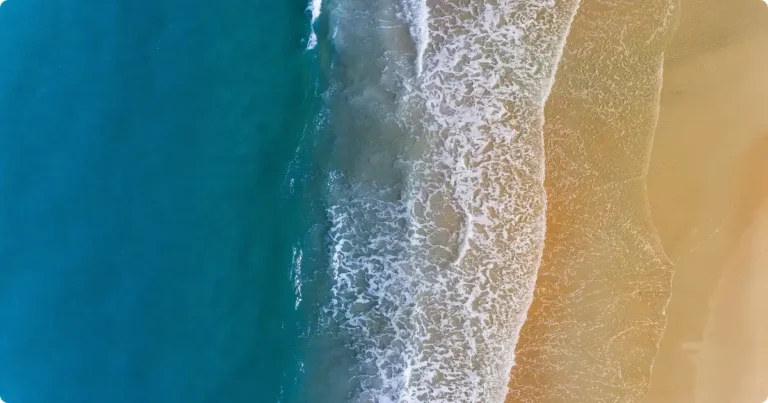 Aerial view of Eagle Beach Aruba showing turquoise water and white sand shoreline