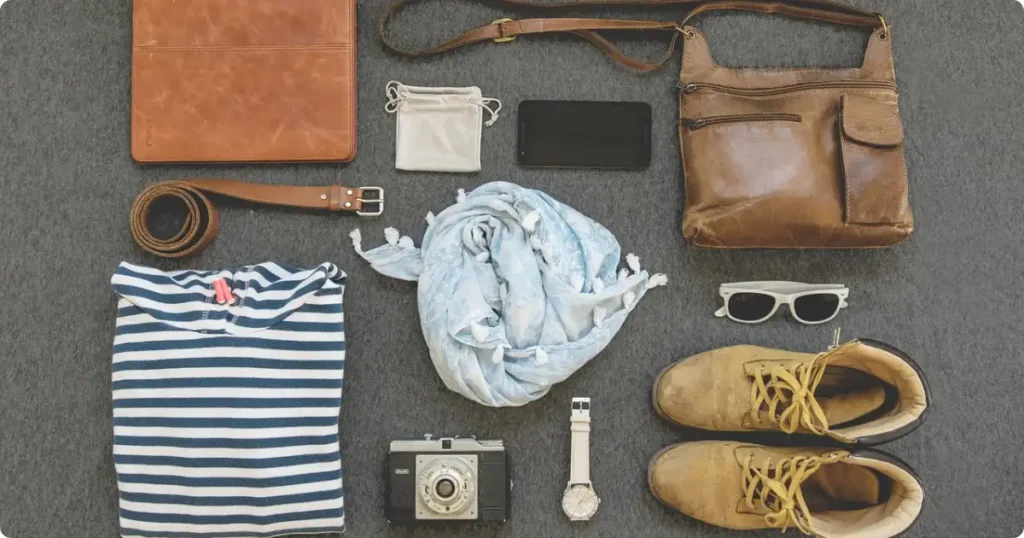 Flat lay of women's safari shirts in khaki olive and grey on wood surface