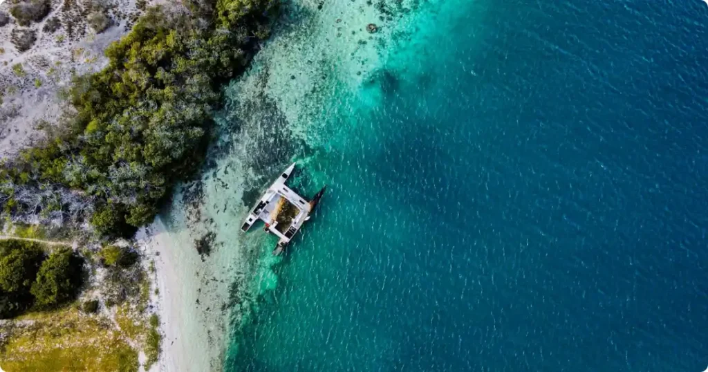 Best Caribbean Islands for Families: Ranked by Age and Budget Aerial view of turquoise Caribbean coastline with white sand beach, ideal for a family vacation