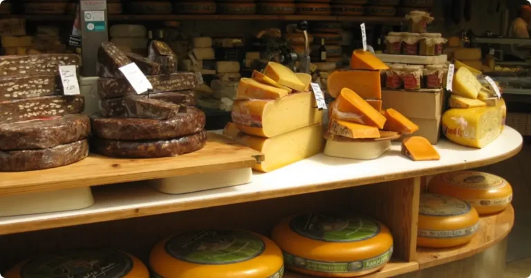 Best Food Tours in Europe: 10 Cities Ranked by Style and What You’ll Eat Traveler sampling local food at a European market on a guided food tour, wooden table with artisan produce