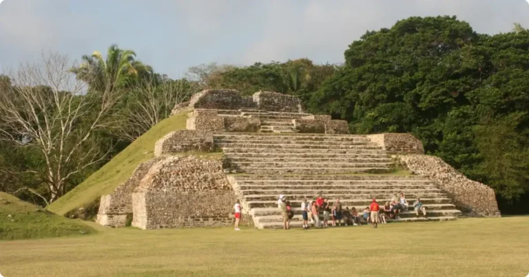 Best Mayan Ruins in Belize: ATM Cave, Lamanai & More Ancient Maya pyramid rising above jungle canopy at Caracol archaeological site in Belize