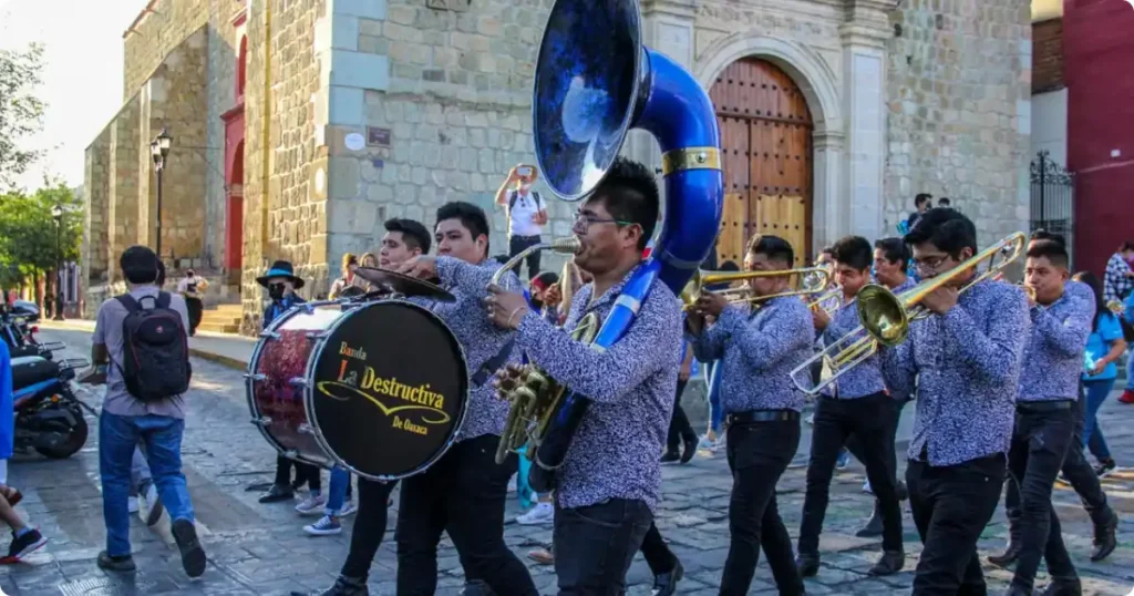 Callejoneada musical street parade through the narrow alleyways of Guanajuato Mexico at night, traditional student musicians in costume