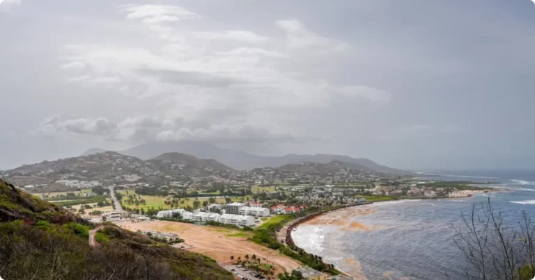 Aerial view of Nevis island coastline with turquoise Caribbean water and Nevis Peak in background
