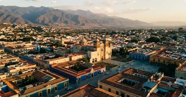Oaxaca Mexico Travel Guide: Food, Ruins & What to Actually Do Aerial view of Oaxaca City historic centre at golden hour with mountains