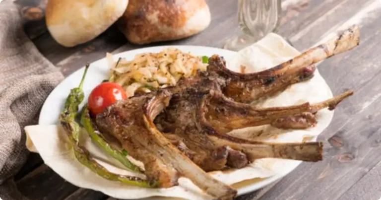 What to Eat in Iceland: A Food Guide for US & UK Travelers Traditional Icelandic lamb dish served on a rustic wooden table with natural side lighting what to eat in Iceland